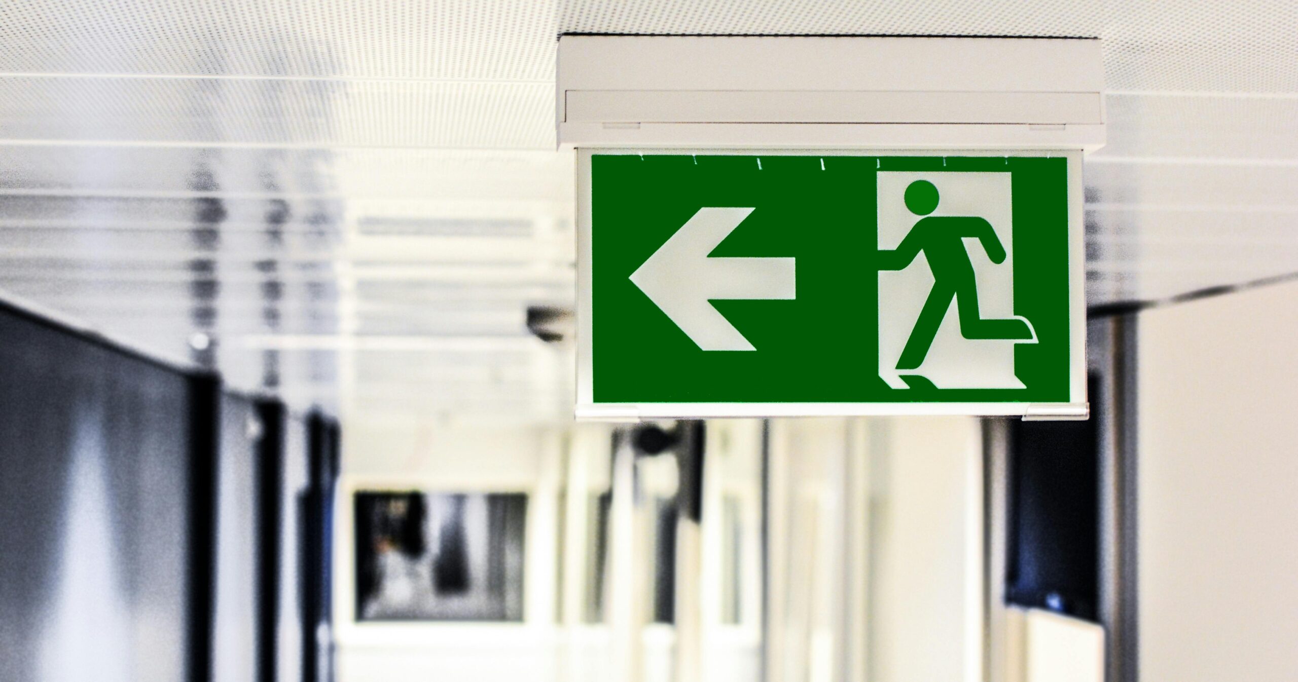 Illuminated emergency exit sign above a doorway